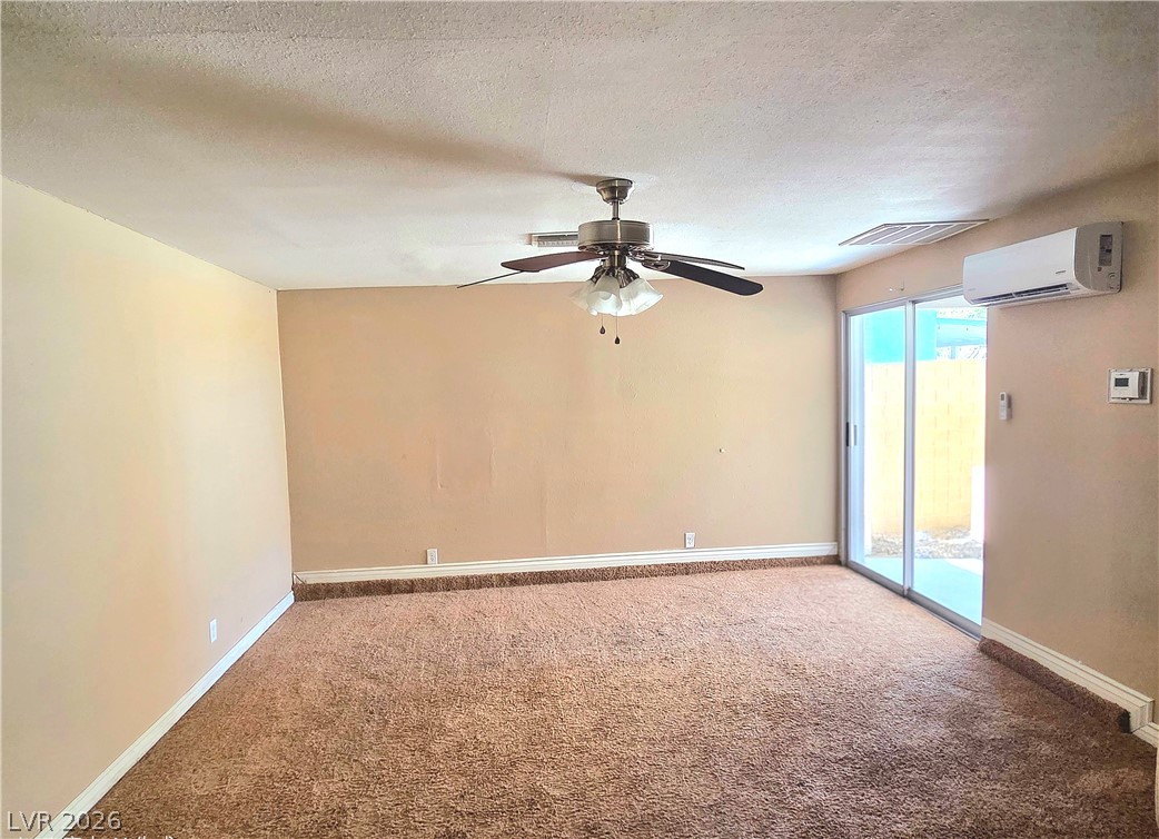 3648 Bronco Road Las Vegas, NV 89103 - Photo 9 of 24 A well-proportioned room with warm carpeting and direct outdoor access through sliding doors.
