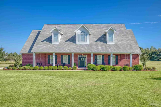 a view of a house with a chairs in patio