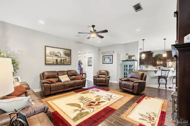 a kitchen with stainless steel appliances granite countertop a sink refrigerator and cabinets