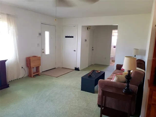 a living room with furniture and a lamp