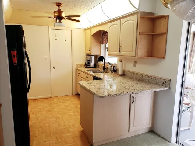 a kitchen with stainless steel appliances granite countertop a sink and refrigerator