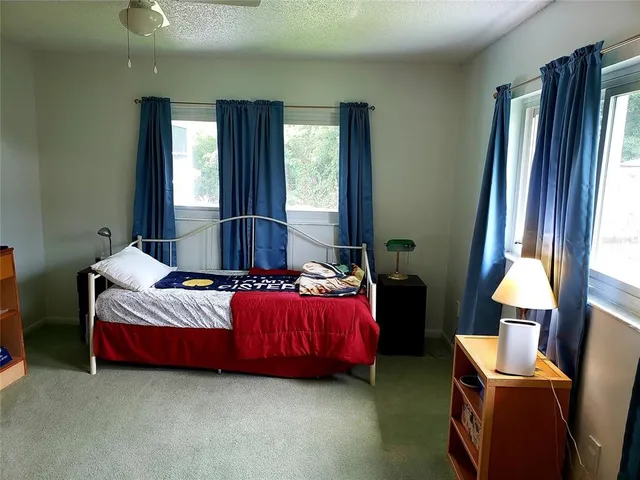 a bedroom with bed and window