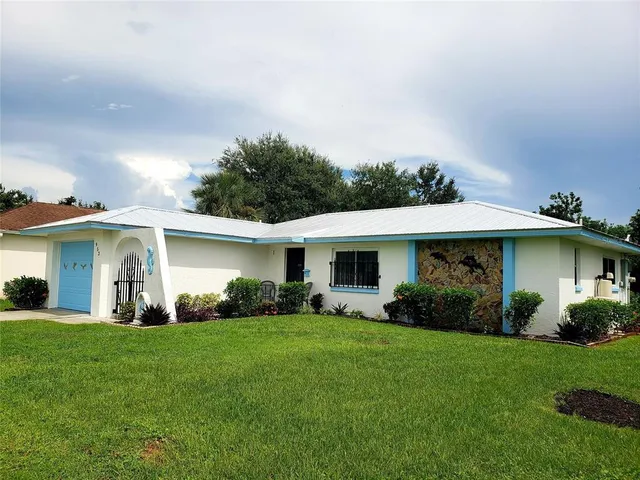 a front view of house with yard and green space