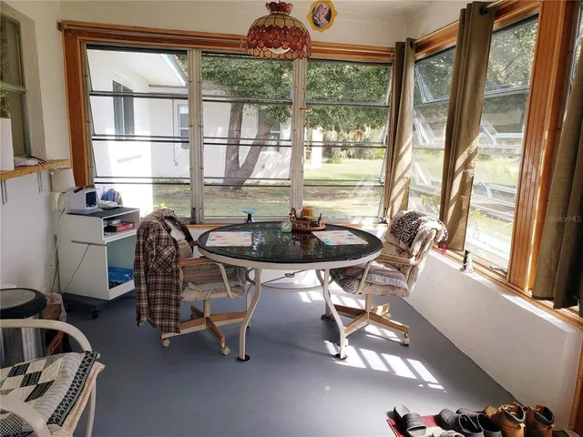 a dining room with furniture a chandelier and wooden floor