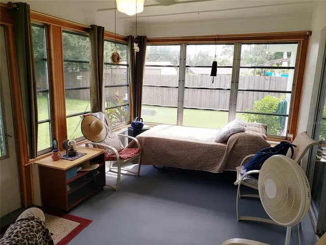 a bedroom with furniture and a window
