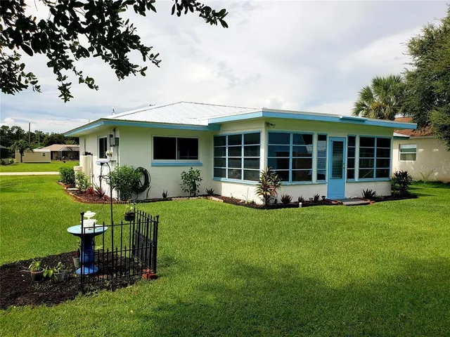 a view of a house with backyard porch and garden