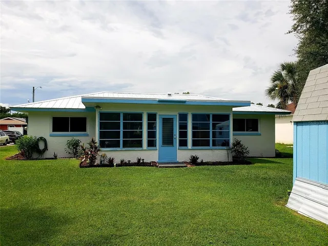 a front view of a house with a yard and porch