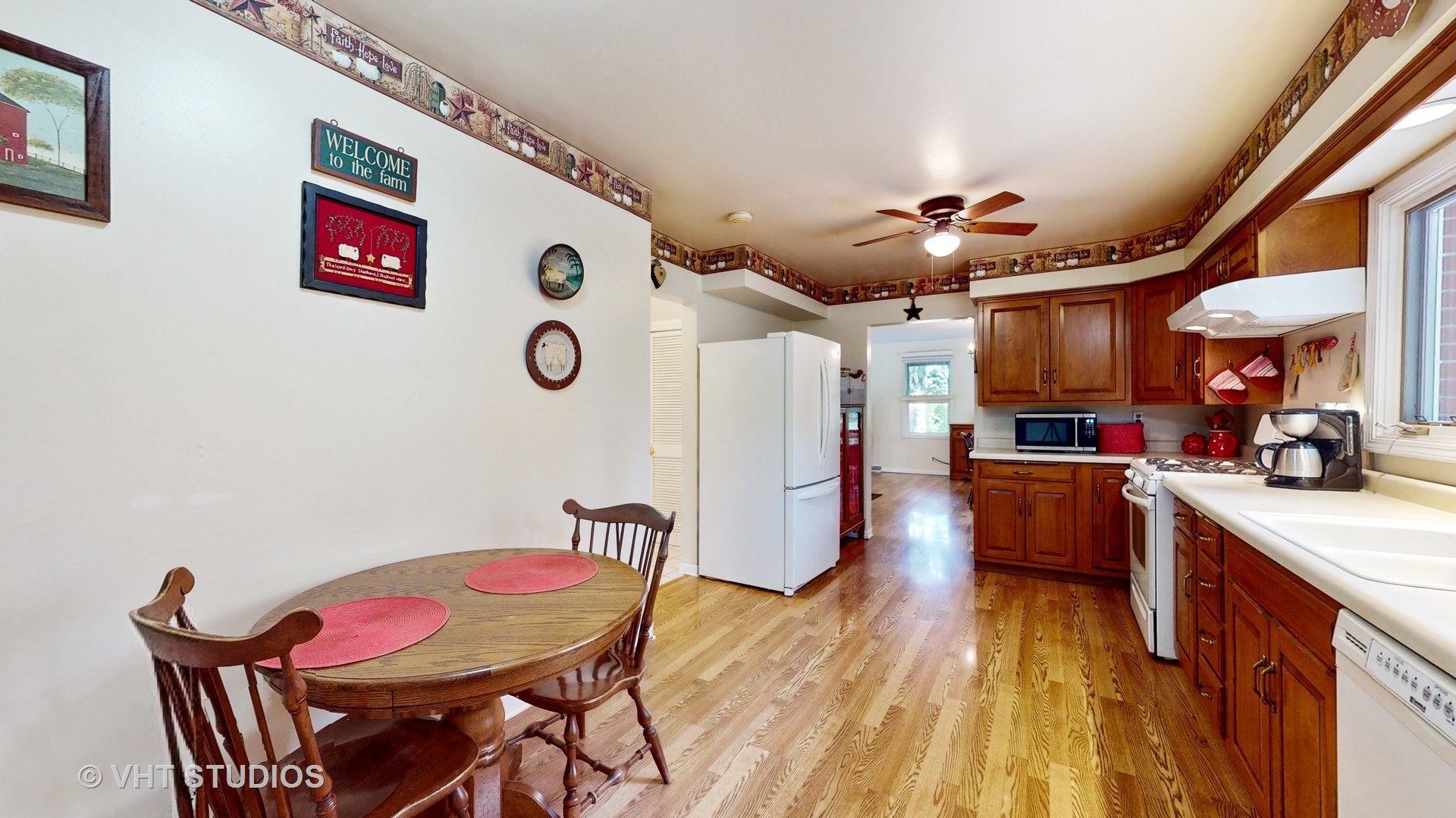 41W965 Empire Road St. Charles, IL 60175 - Photo 12 of 44 a kitchen with stainless steel appliances granite countertop a refrigerator a sink dishwasher a dining table and chairs with wooden floor