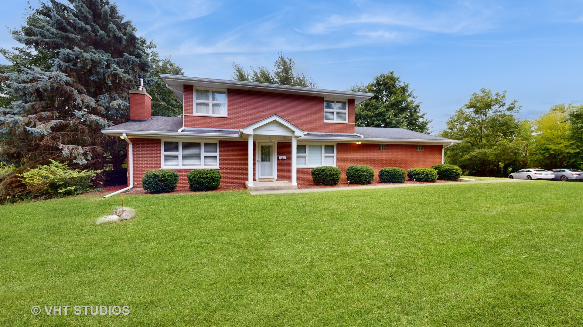 41W965 Empire Road St. Charles, IL 60175 - Photo 2 of 44 a front view of a house with a yard and trees