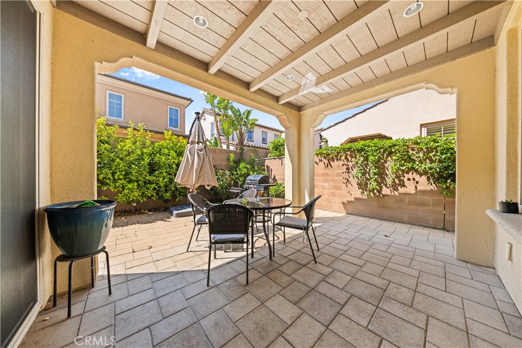 63 Birmingham Irvine, CA 92620 - Photo 24 of 28 a view of a patio with table and chairs and potted plants