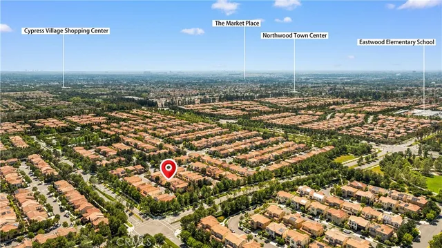 an aerial view of a residential houses with yard