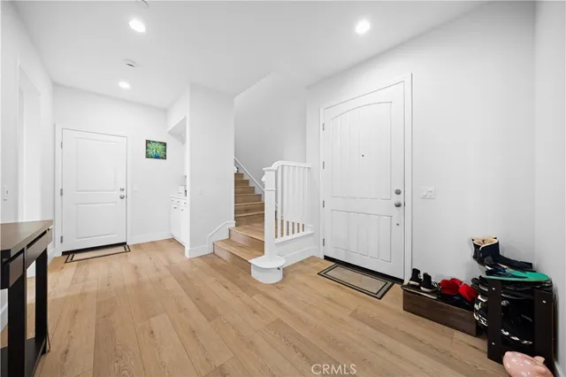 a view of a room with wooden floor and white walls
