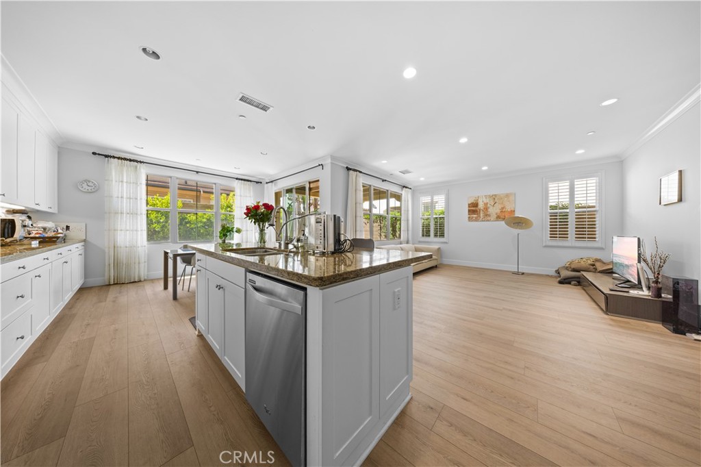 63 Birmingham Irvine, CA 92620 - Photo 7 of 28 a kitchen with counter top space and wooden floor