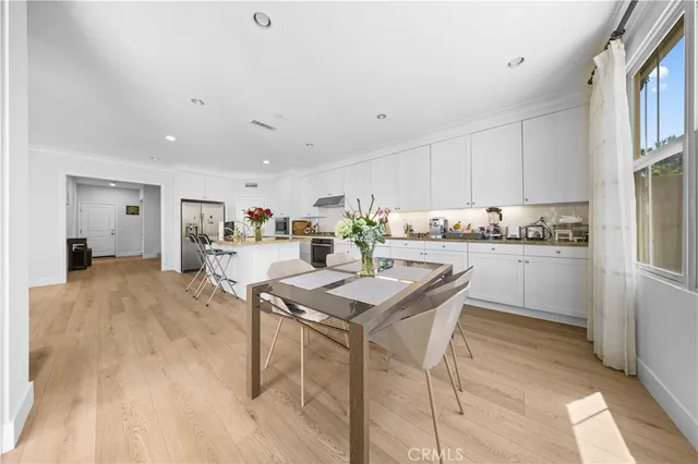 a kitchen with a table and chairs in it