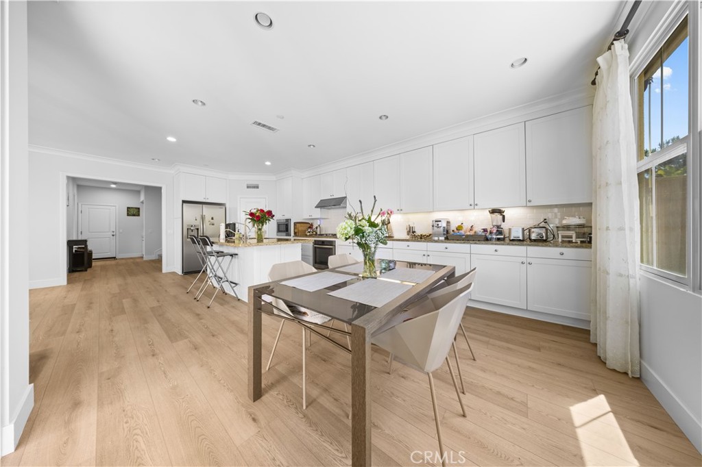63 Birmingham Irvine, CA 92620 - Photo 8 of 28 a kitchen with a table and chairs in it