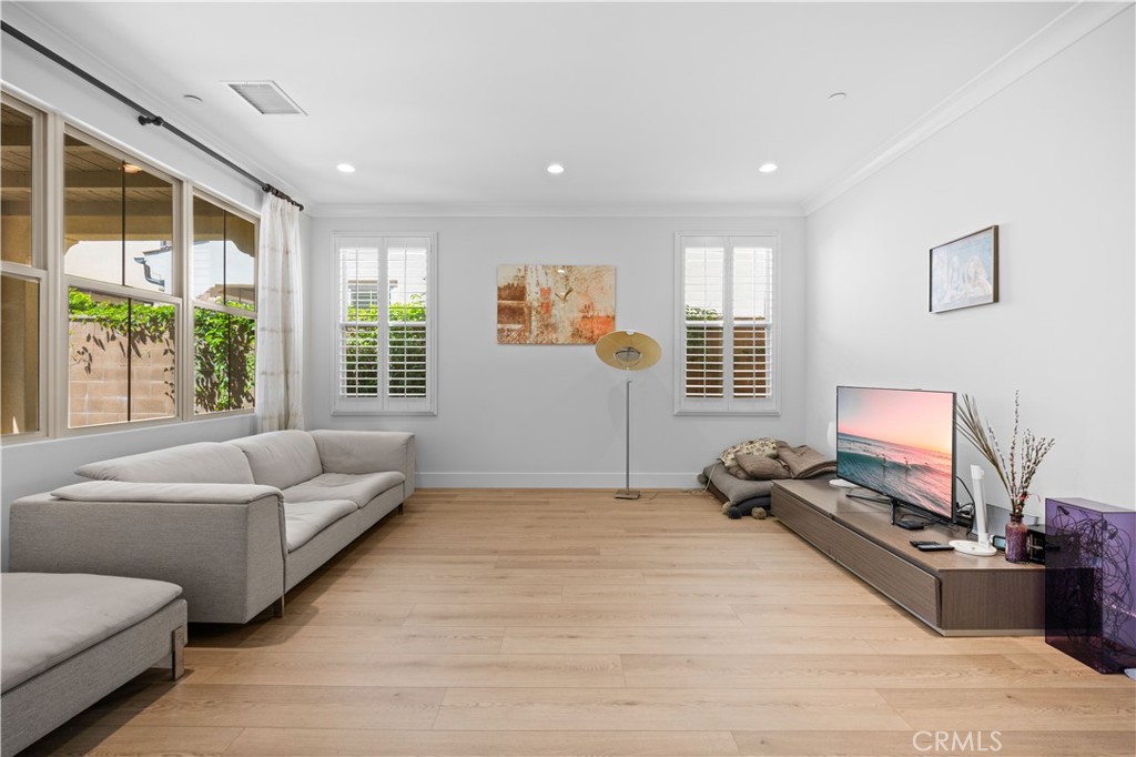 63 Birmingham Irvine, CA 92620 - Photo 9 of 28 a living room with furniture and a flat screen tv