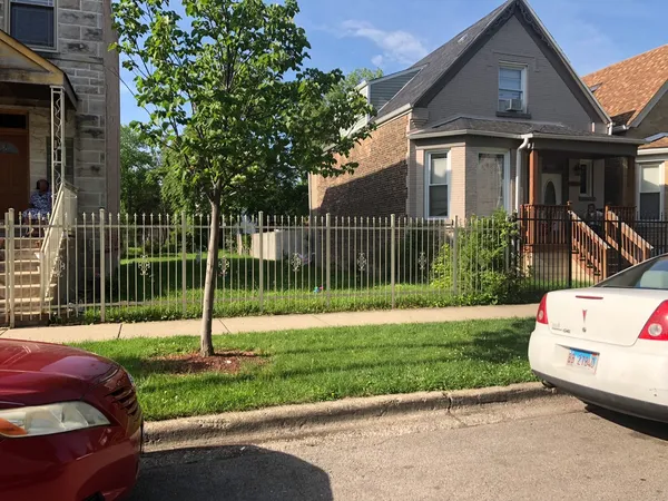 a front view of a house with a yard table and chairs