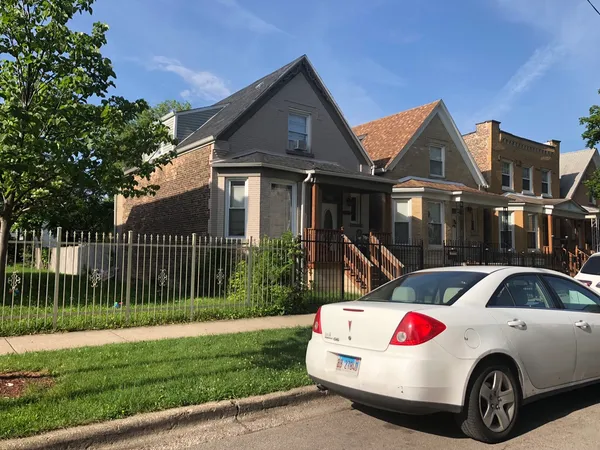a front view of a house with a garden
