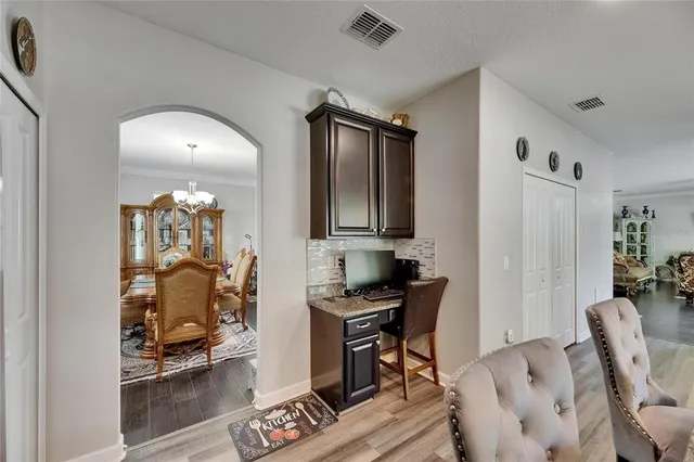 a large living room with furniture a flat screen tv and a large window