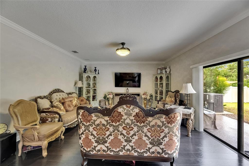 5057 Ivory Stone Drive Wimauma, FL 33598 - Photo 17 of 46 a living room with furniture and a flat screen tv