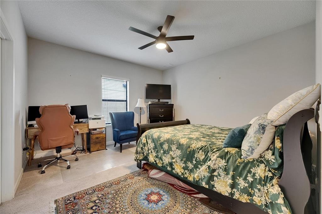 5057 Ivory Stone Drive Wimauma, FL 33598 - Photo 19 of 46 a bedroom with a bed and furniture