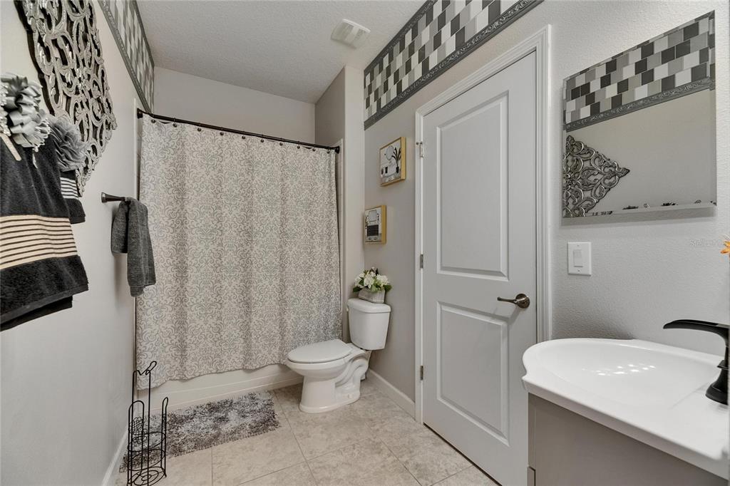 5057 Ivory Stone Drive Wimauma, FL 33598 - Photo 21 of 46 a bathroom with a sink toilet and shower