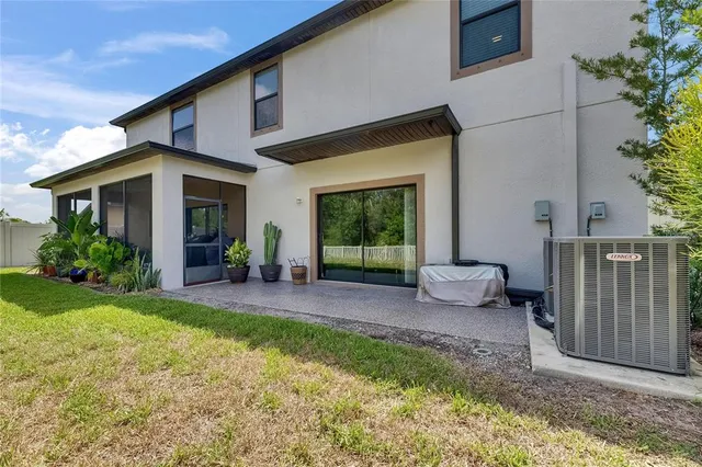 an aerial view of a house with a swimming pool patio and outdoor seating