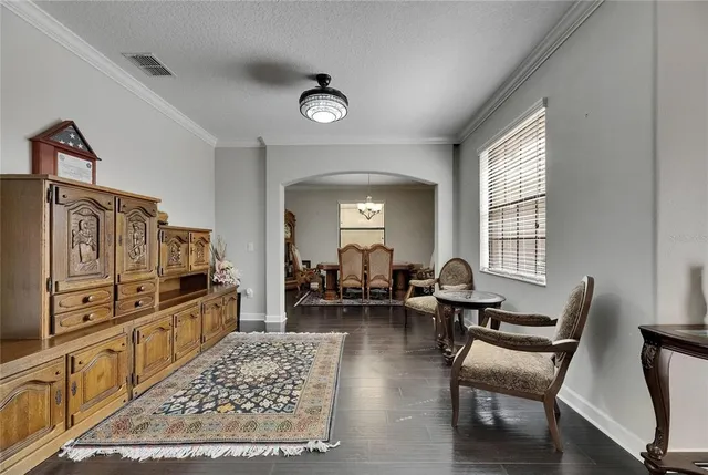a dining room with furniture window and wooden floor