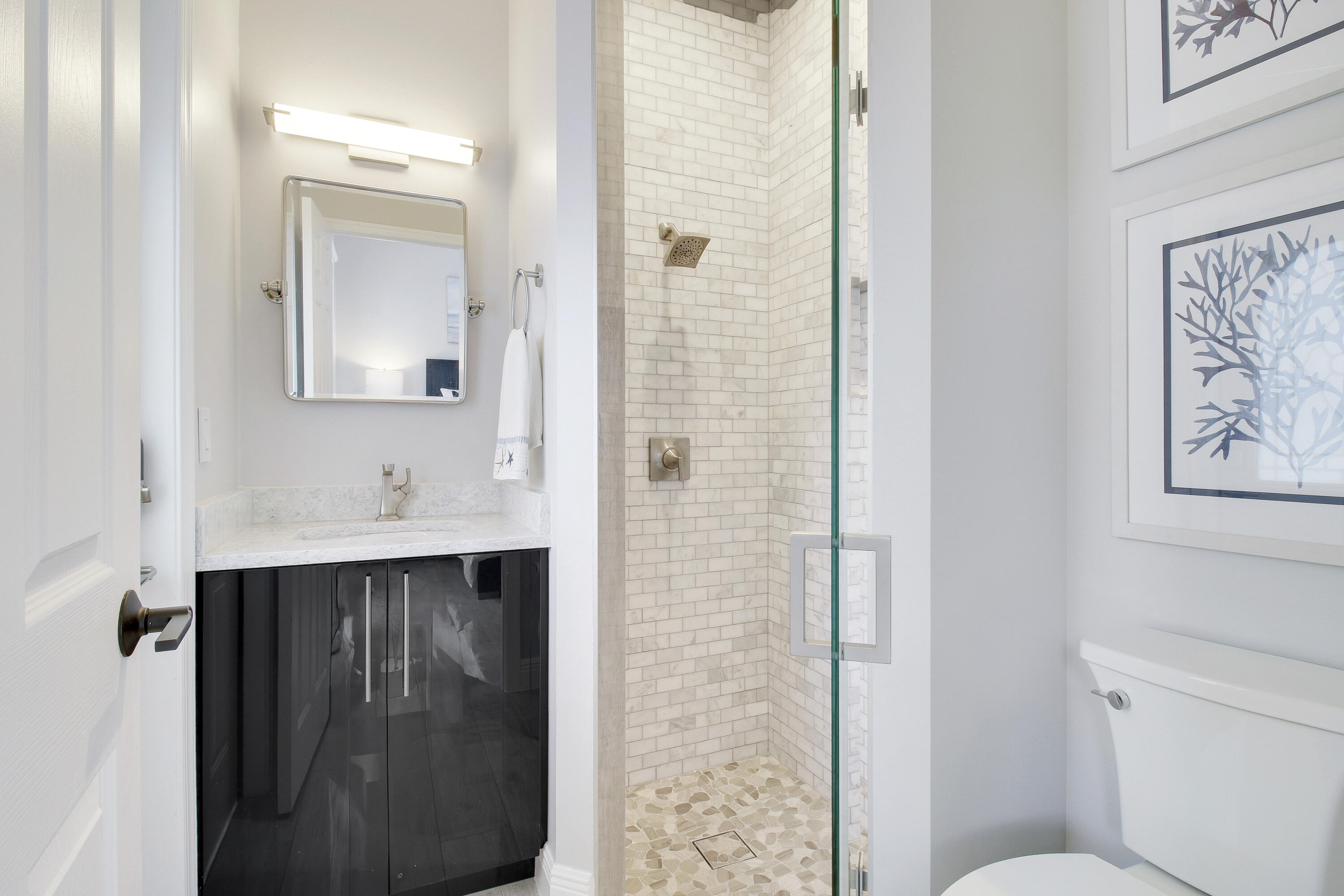 7606 La Corniche Circle Boca Raton, FL 33433 - Photo 11 of 49 a bathroom with a sink and mirror with toilet