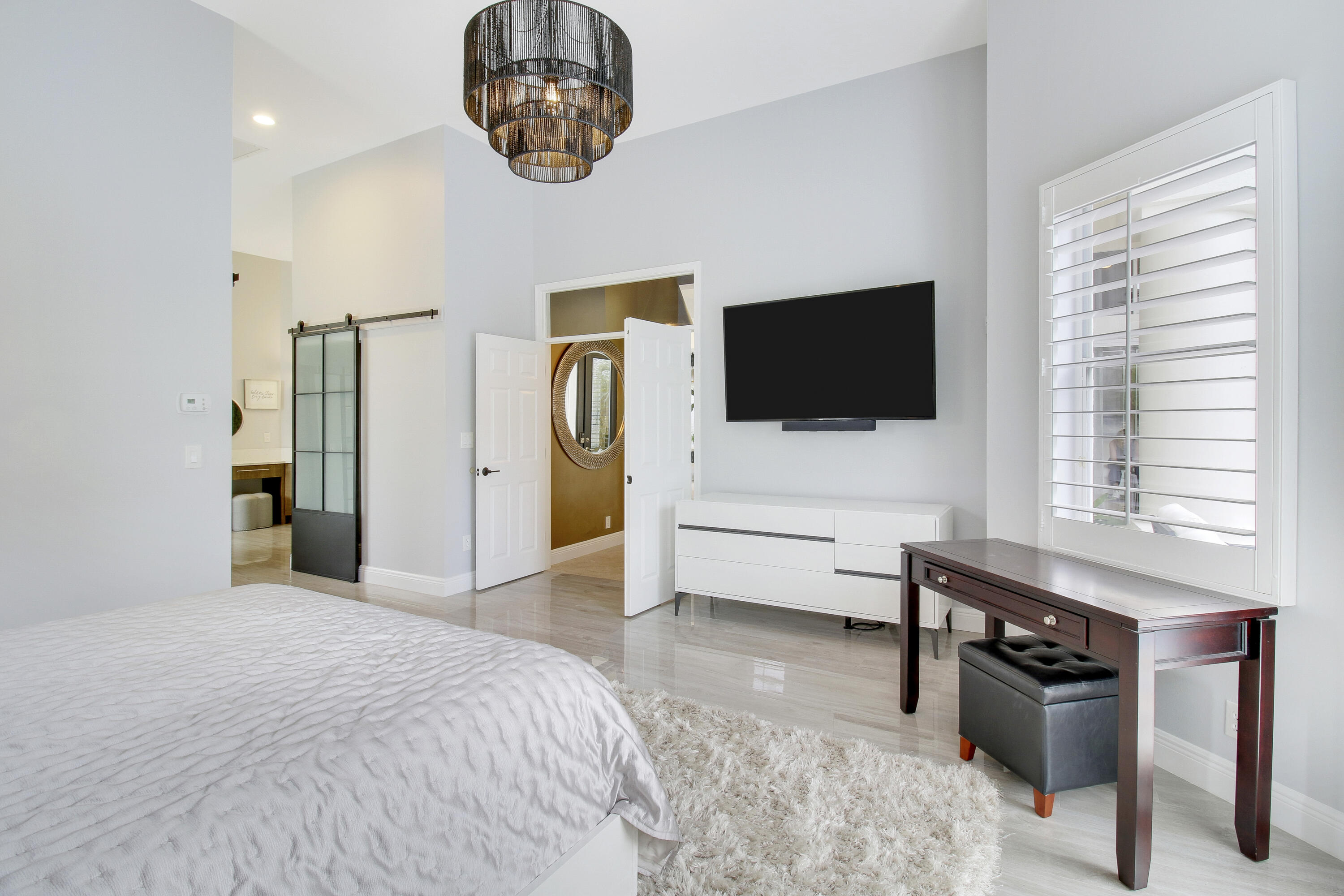 7606 La Corniche Circle Boca Raton, FL 33433 - Photo 27 of 49 a bedroom with a bed and a flat screen tv