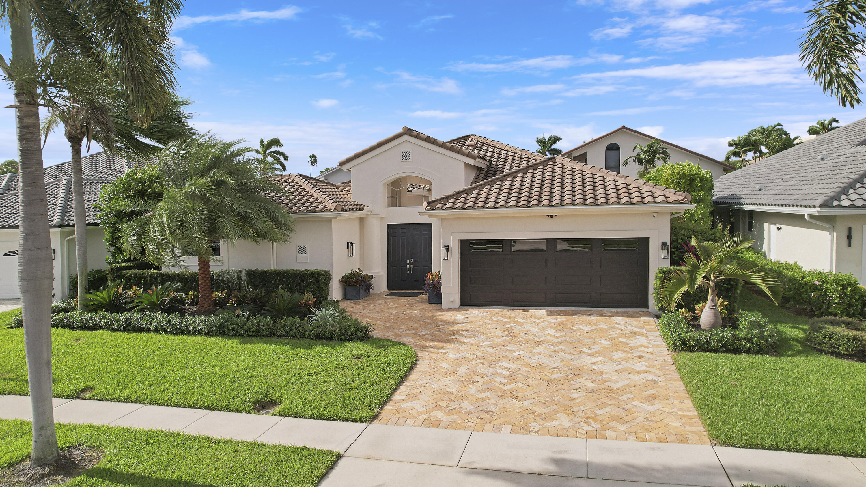 7606 La Corniche Circle Boca Raton, FL 33433 - Photo 40 of 49 a front view of a house with a garden