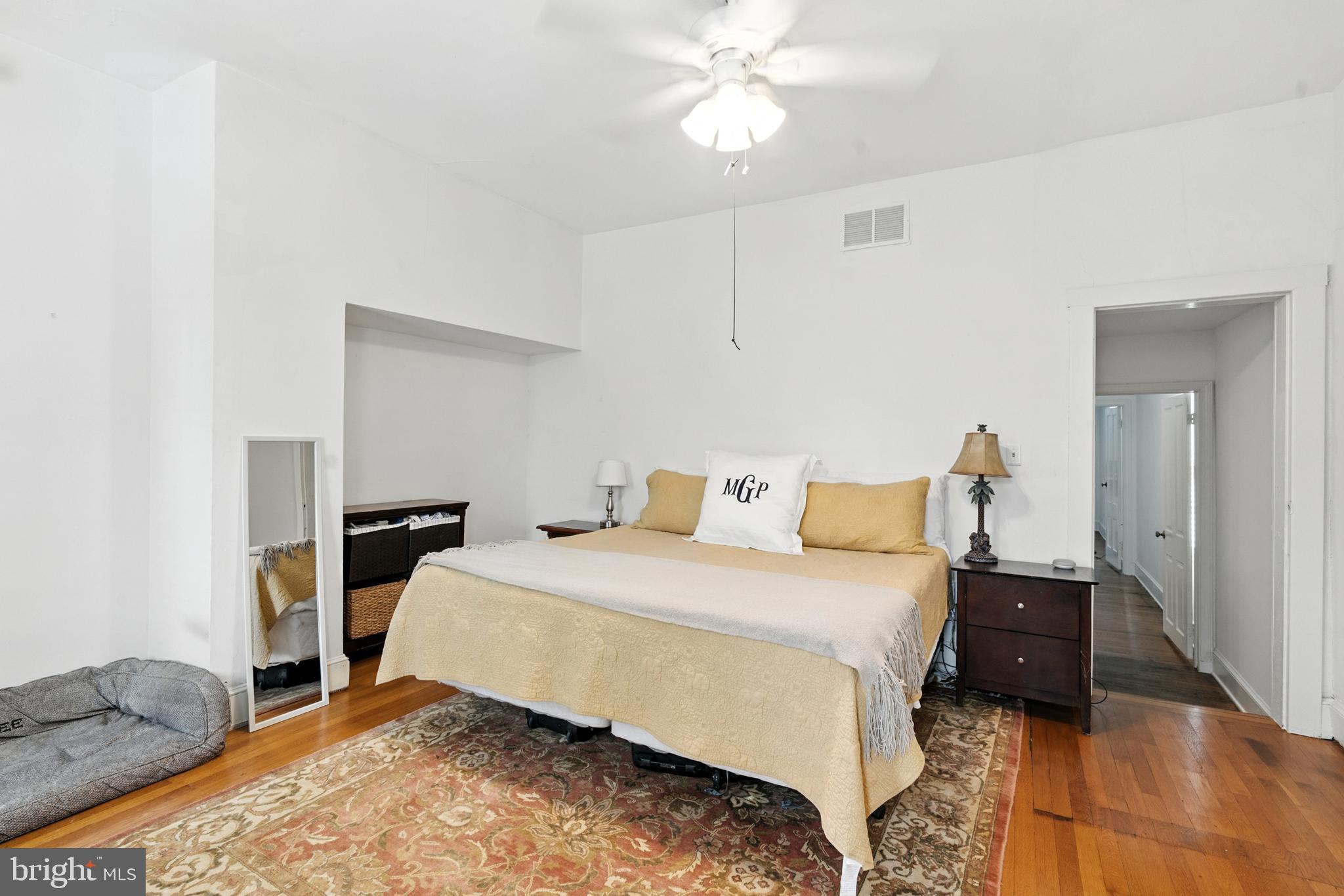 110 South Mill Street Chestertown, MD 21620 - Photo 15 of 39 a bedroom with a bed and a chandelier