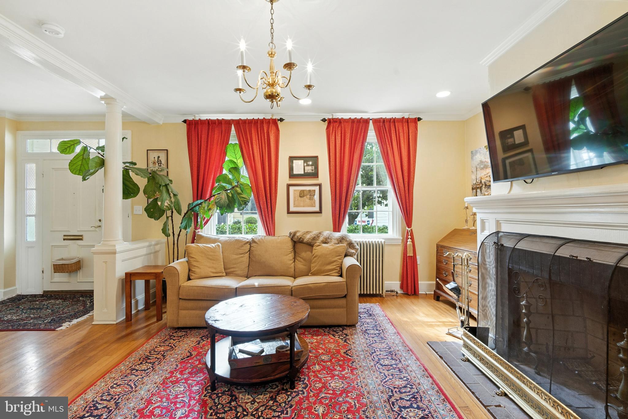 110 South Mill Street Chestertown, MD 21620 - Photo 4 of 39 a living room with furniture a fireplace and a chandelier