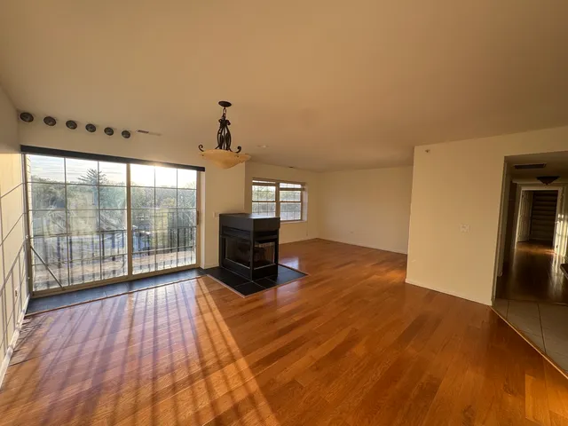 a view of a livingroom with furniture window and wooden floor