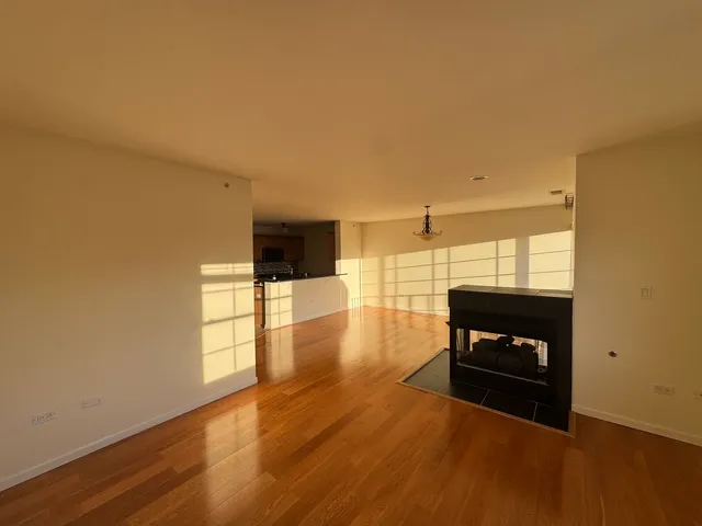 a kitchen with a refrigerator and a stove top oven