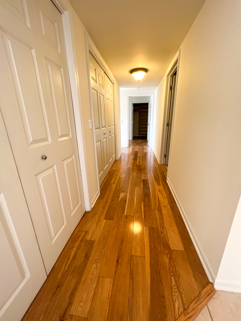 30 Nugent Street, Unit 430 Glenwood, IL 60425 - Photo 2 of 18 a view of a hallway with wooden floor and staircase
