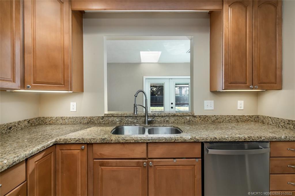 2891 Southeast Farley Road Port St. Lucie, FL 34952 - Photo 16 of 53 a kitchen with granite countertop a sink and cabinets
