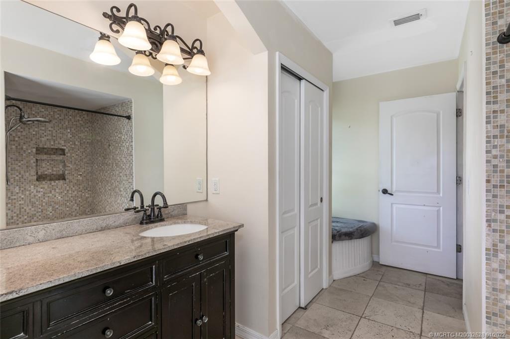 2891 Southeast Farley Road Port St. Lucie, FL 34952 - Photo 28 of 53 a bathroom with a sink vanity and a mirror