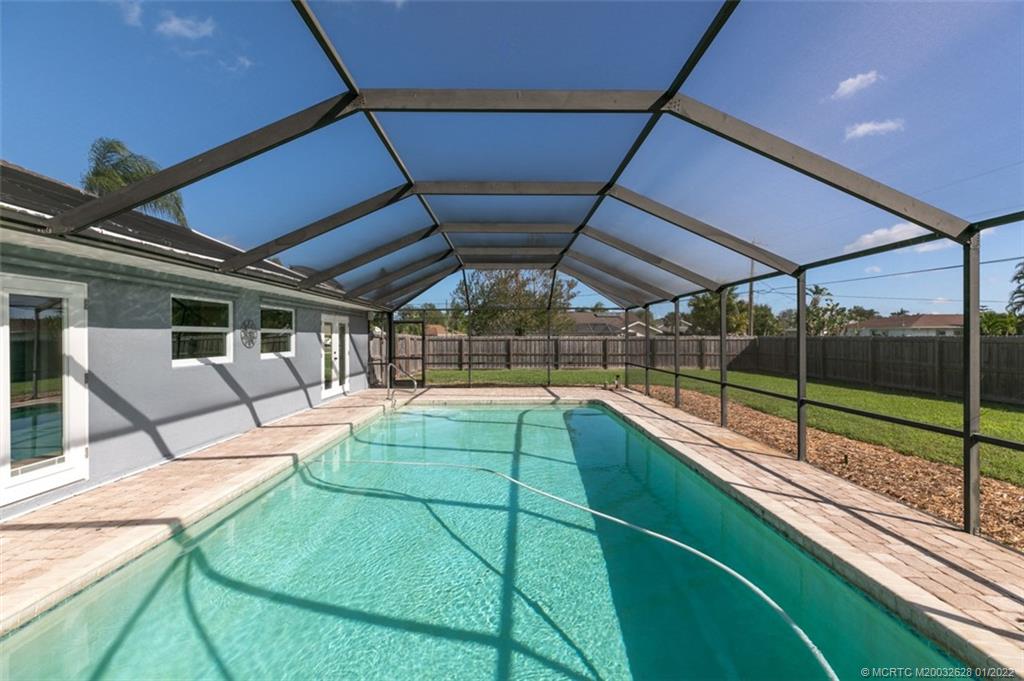 2891 Southeast Farley Road Port St. Lucie, FL 34952 - Photo 30 of 53 a view of a backyard with a swimming pool