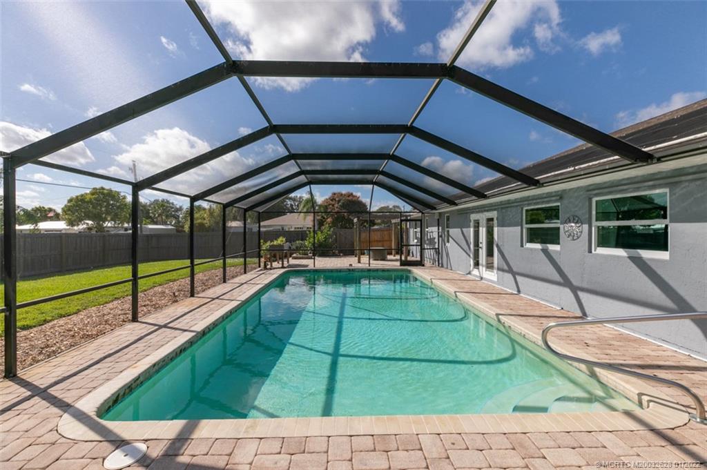 2891 Southeast Farley Road Port St. Lucie, FL 34952 - Photo 32 of 53 a view of a swimming pool with a porch