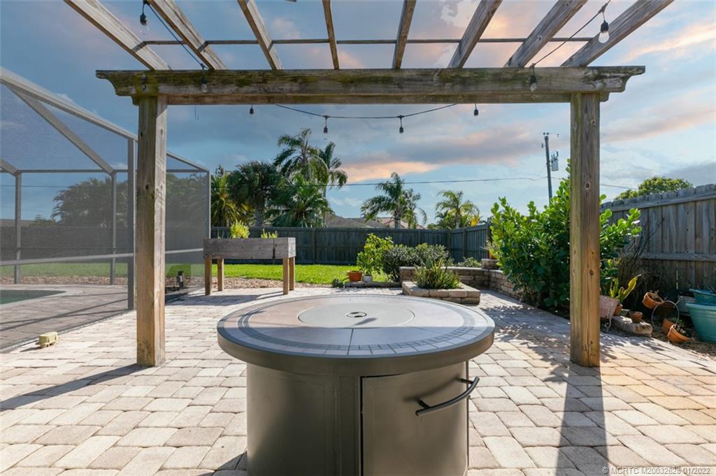 2891 Southeast Farley Road Port St. Lucie, FL 34952 - Photo 40 of 53 a view of a patio with a table and chairs