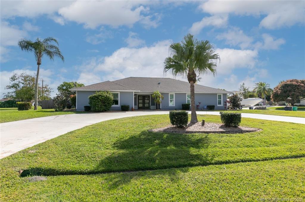2891 Southeast Farley Road Port St. Lucie, FL 34952 - Photo 4 of 53 a view of a swimming pool and a yard