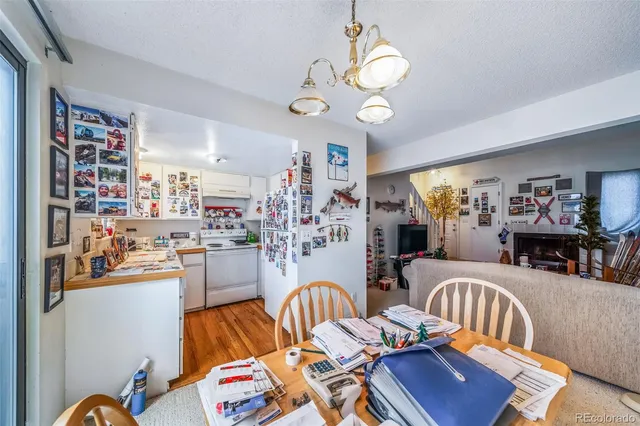a living room with lots of furniture and chandelier