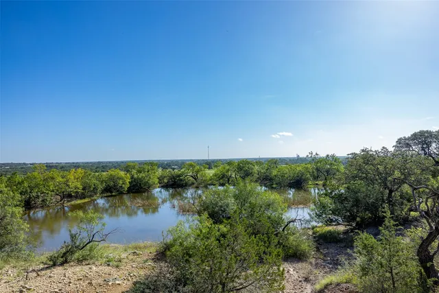 a view of a lake view with houses in back