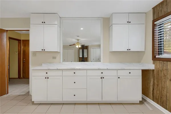 a kitchen with white cabinets