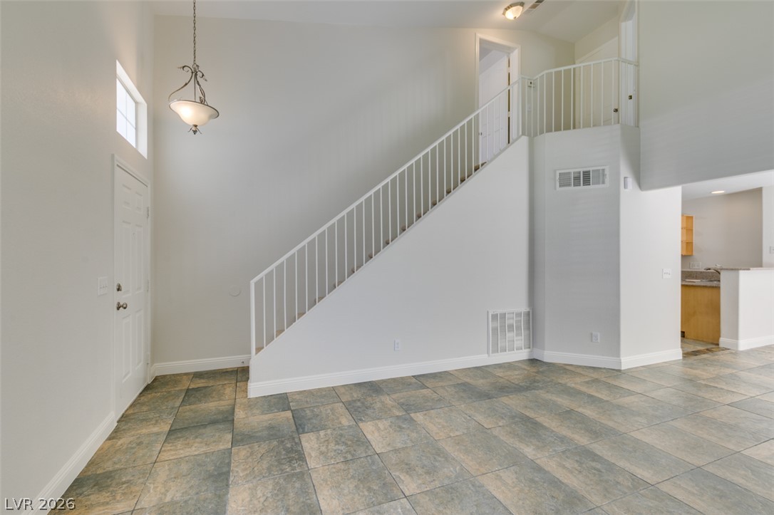 200 Luninborg Street Henderson, NV 89074 - Photo 35 of 40 A graceful staircase ascends to an upper landing, complemented by practical and elegant tile flooring.