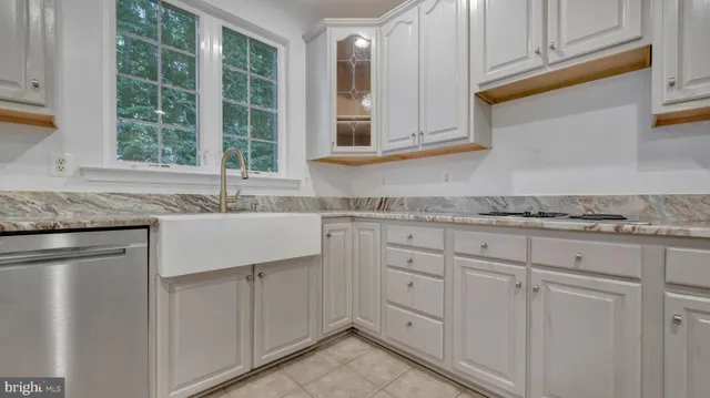 an empty room with wooden floor a fireplace and windows