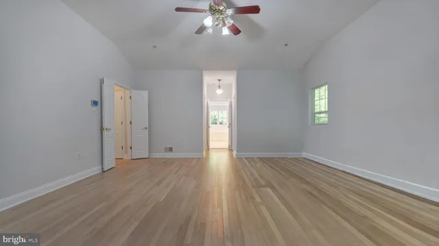 a bathroom with a bathtub a sink a window and a shower