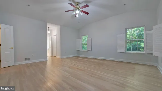 a spacious bathroom with a shower a sink and a mirror