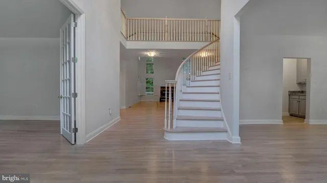 a view of entryway and hall with wooden floor